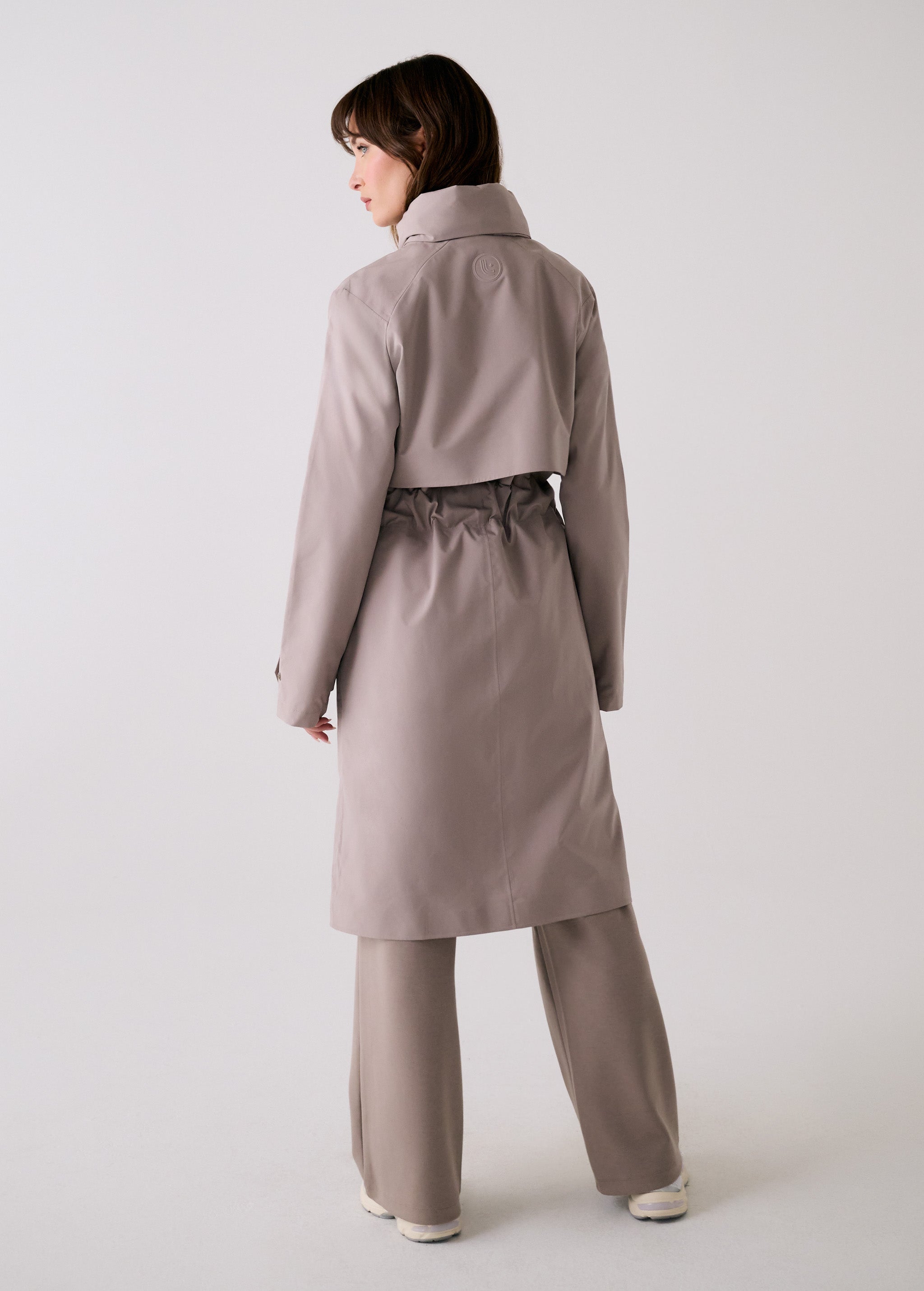 Lolë Alizé Trench Coat in Pebble taupe — fit note: Cut with a relaxed fit for comfortable layering