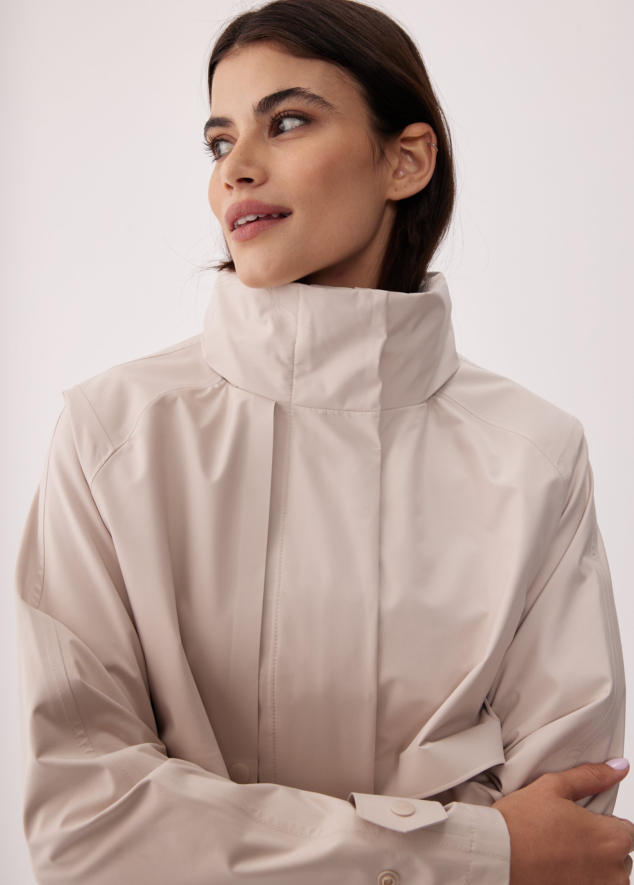 Lolë Alizé Short Trench Coat in Abalone pale greige — fit note: Cut with a relaxed fit for comfortable layering