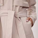 Lolë Alizé Short Trench Coat in Abalone pale greige — fit note: Cut with a relaxed fit for comfortable layering