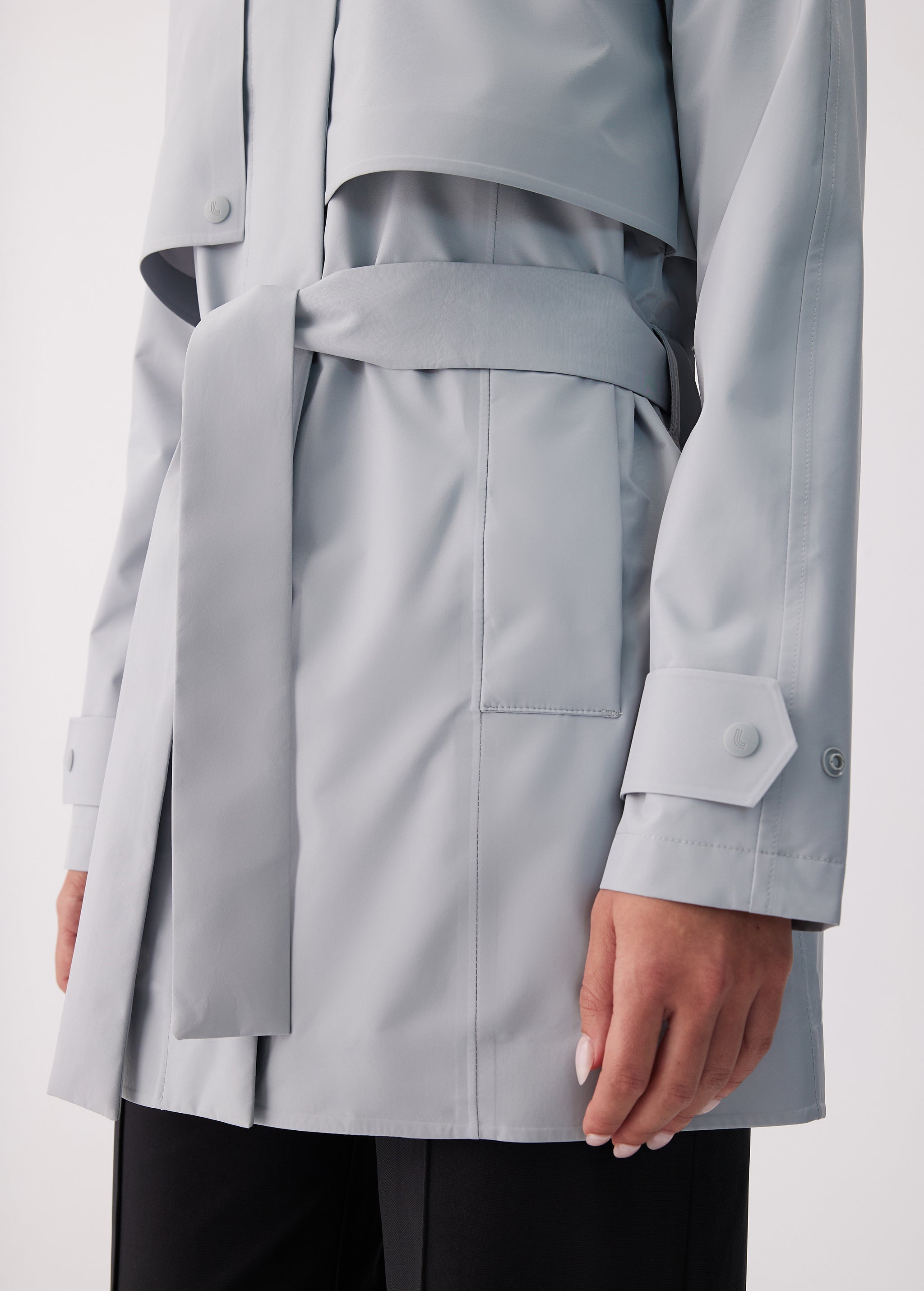 Lolë Alizé Short Trench Coat in Steel light grey — fit note: Cut with a relaxed fit for comfortable layering