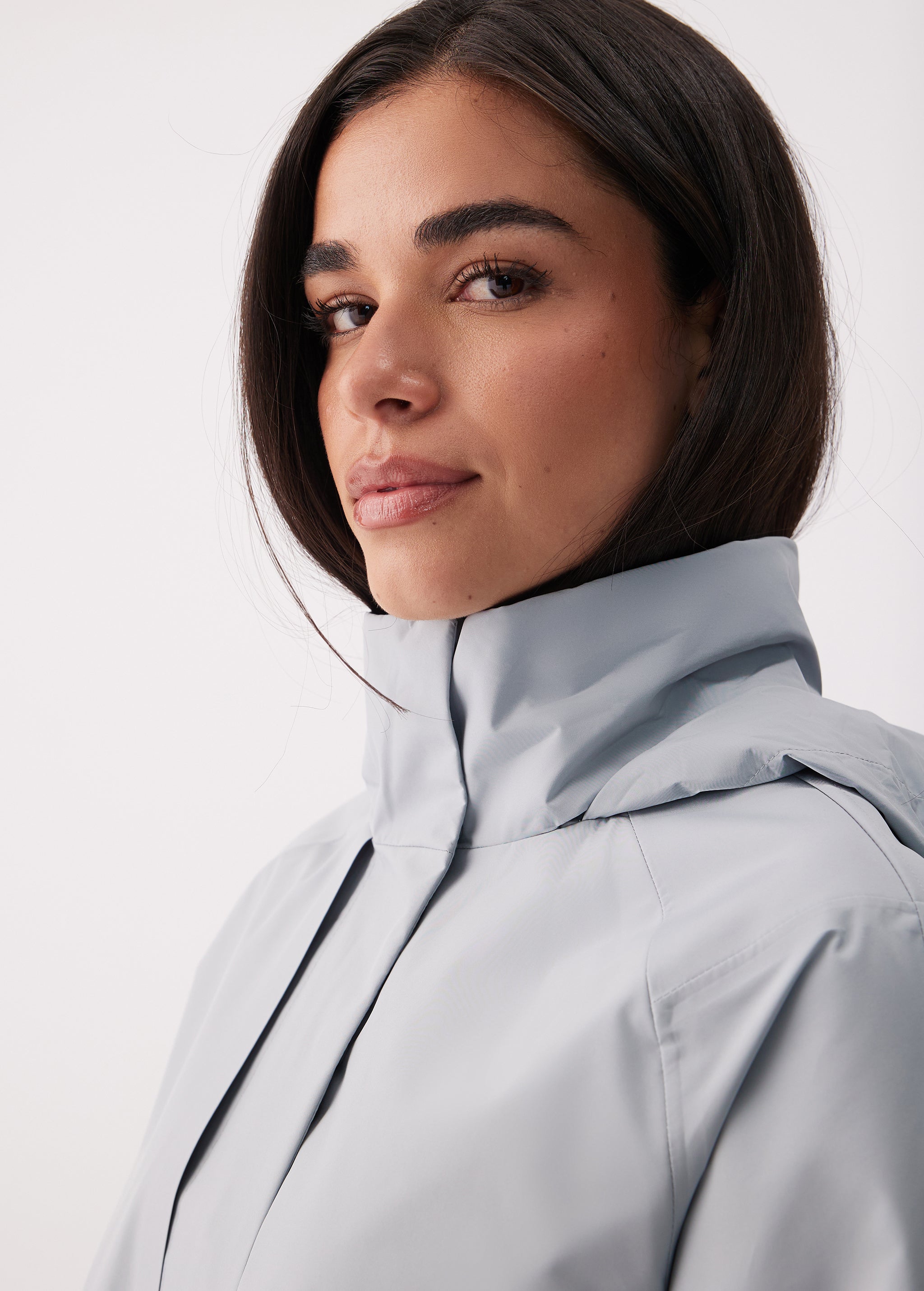 Lolë Alizé Short Trench Coat in Steel light grey — fit note: Cut with a relaxed fit for comfortable layering