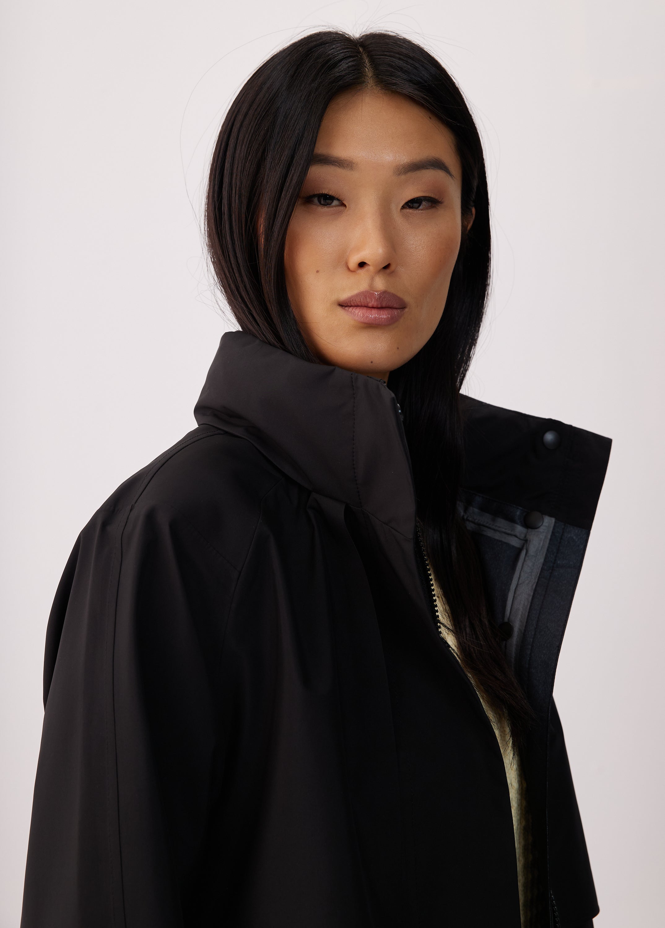 Lolë Alizé Short Trench Coat in black — fit note: Cut with a relaxed fit for comfortable layering