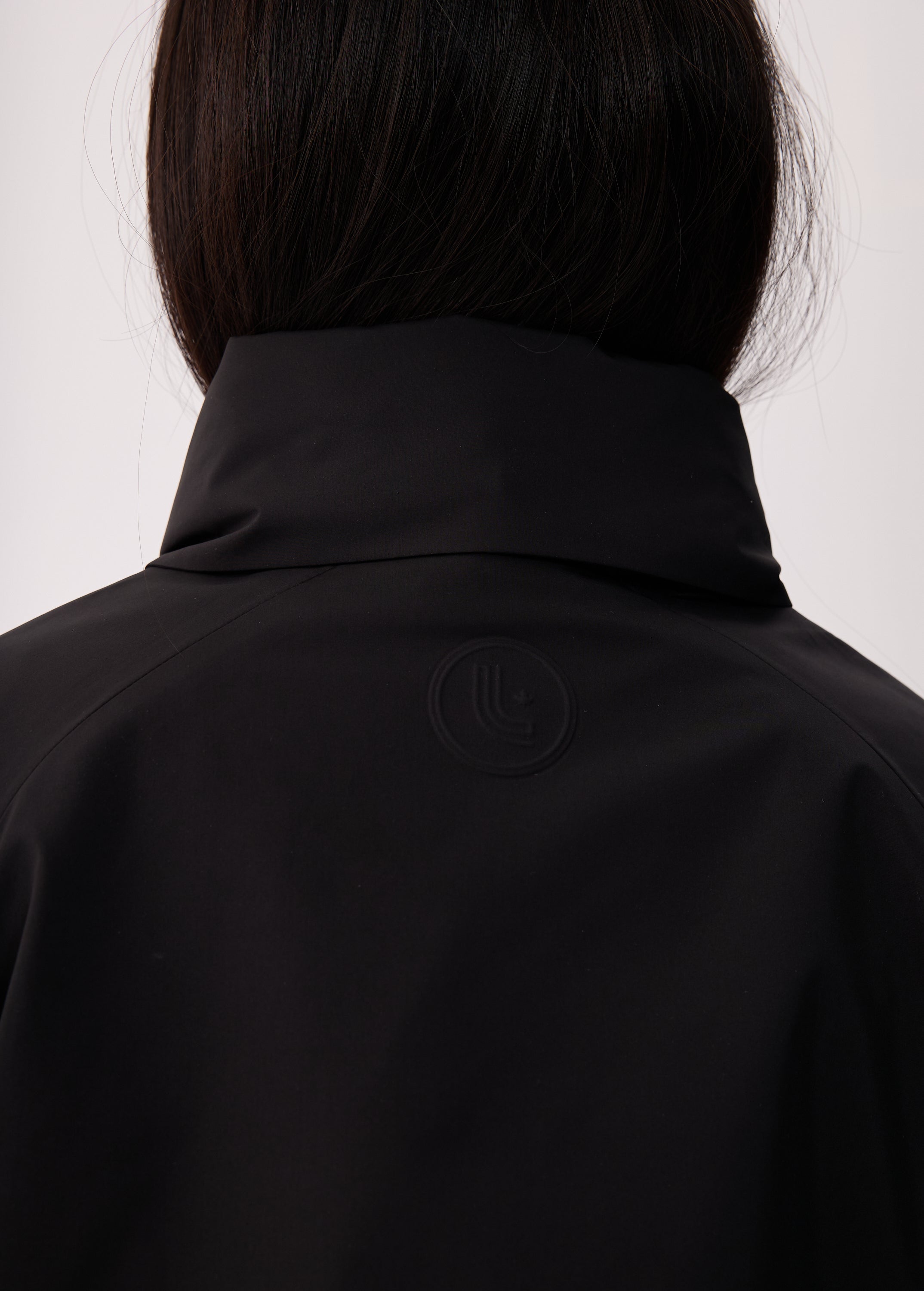 Lolë Alizé Short Trench Coat in black — fit note: Cut with a relaxed fit for comfortable layering