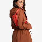 Lolë Piper Oversized Rain Jacket in rust — for a more streamlined fit, consider sizing down