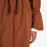 Lolë Piper Oversized Rain Jacket in rust — for a more streamlined fit, consider sizing down