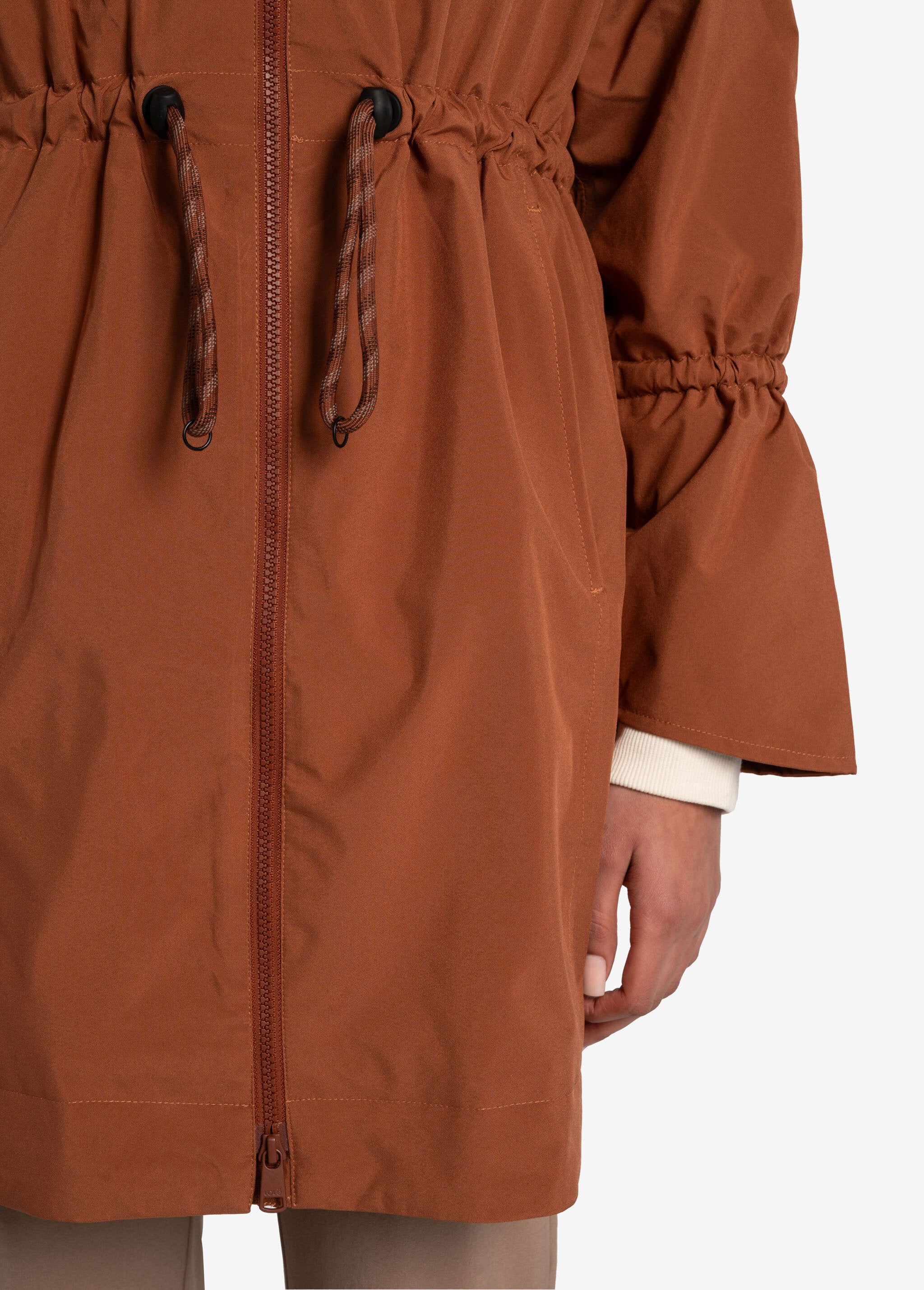 Lolë Piper Oversized Rain Jacket in rust — for a more streamlined fit, consider sizing down