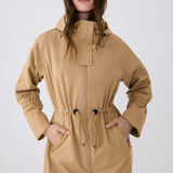 Lolë Piper Oversized Rain Jacket in Carmel tan — for a more streamlined fit, consider sizing down
