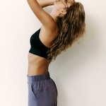 Lolë Power Sport Bra in black — a thick branded strap and hook-and-eye closure serve maximum support