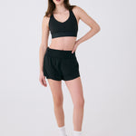 Lolë Power Sport Bra in black — a thick branded strap and hook-and-eye closure serve maximum support