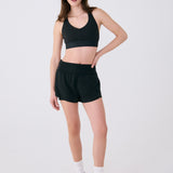 Lolë Power Sport Bra in black — a thick branded strap and hook-and-eye closure serve maximum support