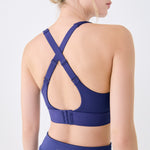 Lolë Power Sport Bra in Dusk navy — a thick branded strap and hook-and-eye closure serve maximum support