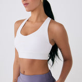 Lolë Power Sport Bra in white — a thick branded strap and hook-and-eye closure serve maximum support