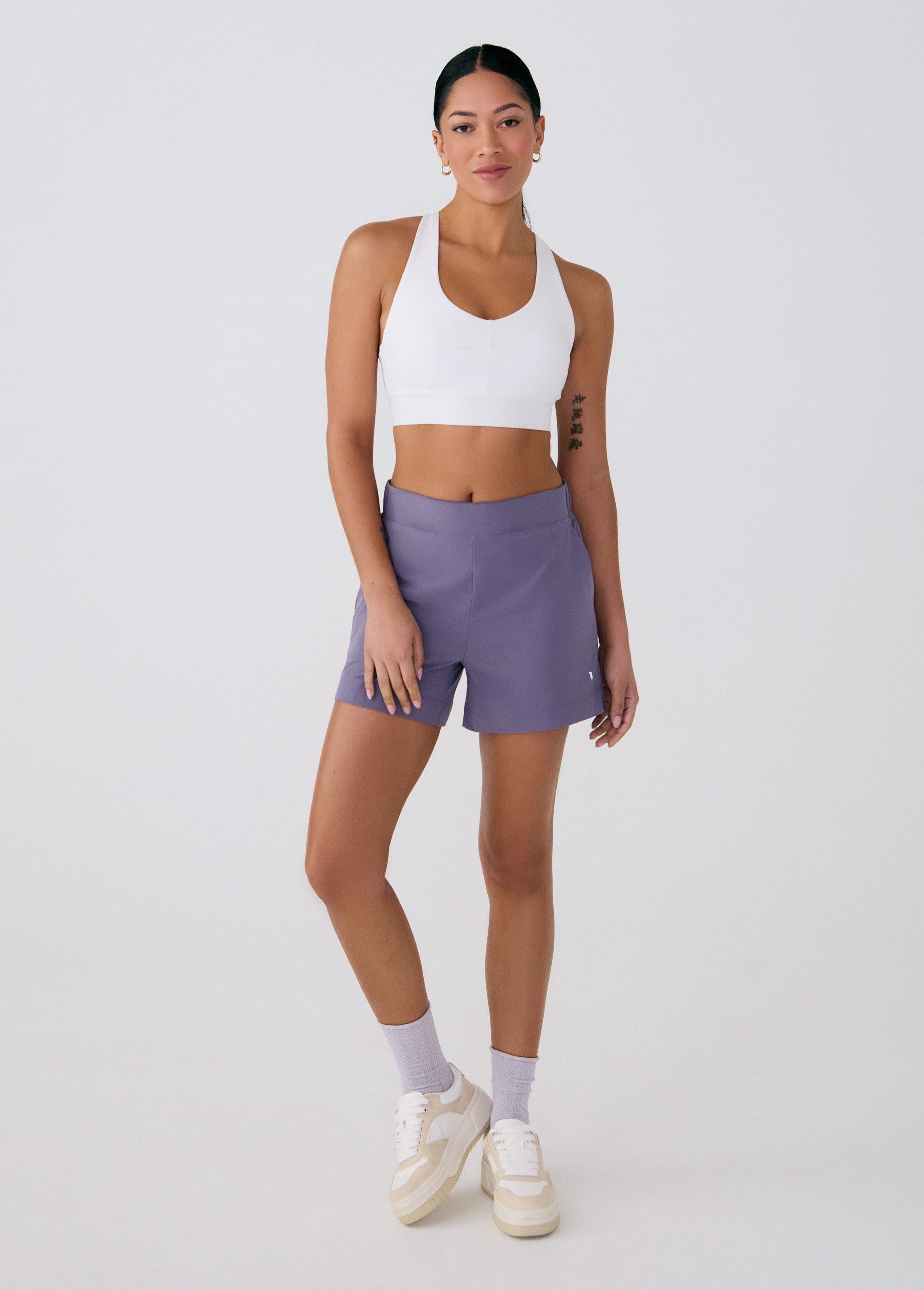 Lolë Power Sport Bra in white — a thick branded strap and hook-and-eye closure serve maximum support