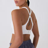 Lolë Power Sport Bra in white — a thick branded strap and hook-and-eye closure serve maximum support