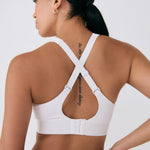 Lolë Power Sport Bra in white — a thick branded strap and hook-and-eye closure serve maximum support