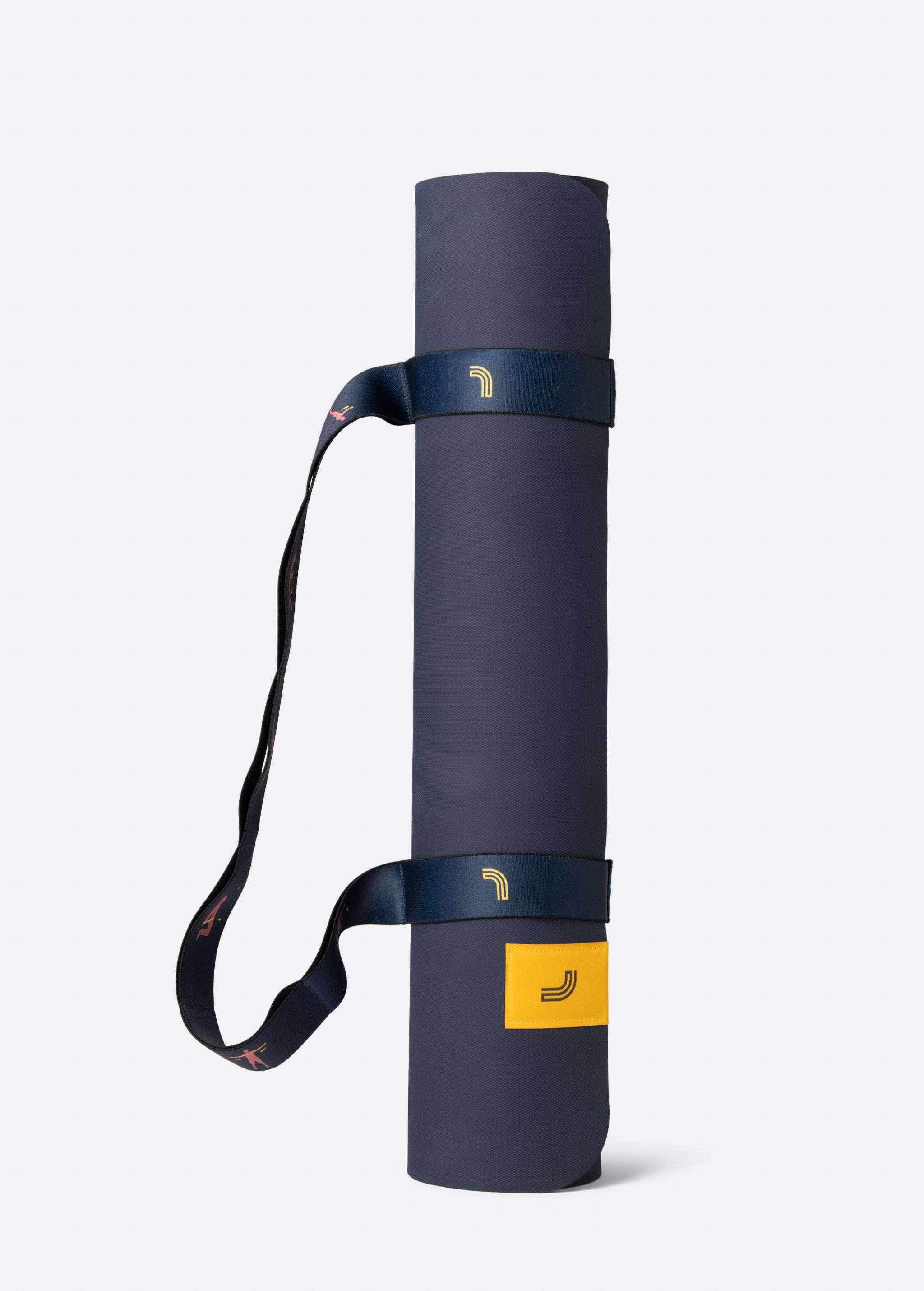 Lolë Pose yoga mat in navy, rolled tightly with the navy strap and yellow logo tab