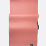 Lolë Pose yoga mat in dusty pink, laid flat showing the dusty pink top with the navy underside beneath