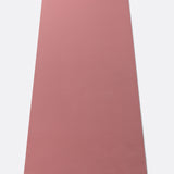Lolë Pose yoga mat in dusty rose, unrolled flat showing the smooth dusty-rose top surface and yellow logo tab