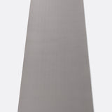 Lolë Pose yoga mat in grey, unrolled flat showing the textured grey underside with the Lolë logo tab