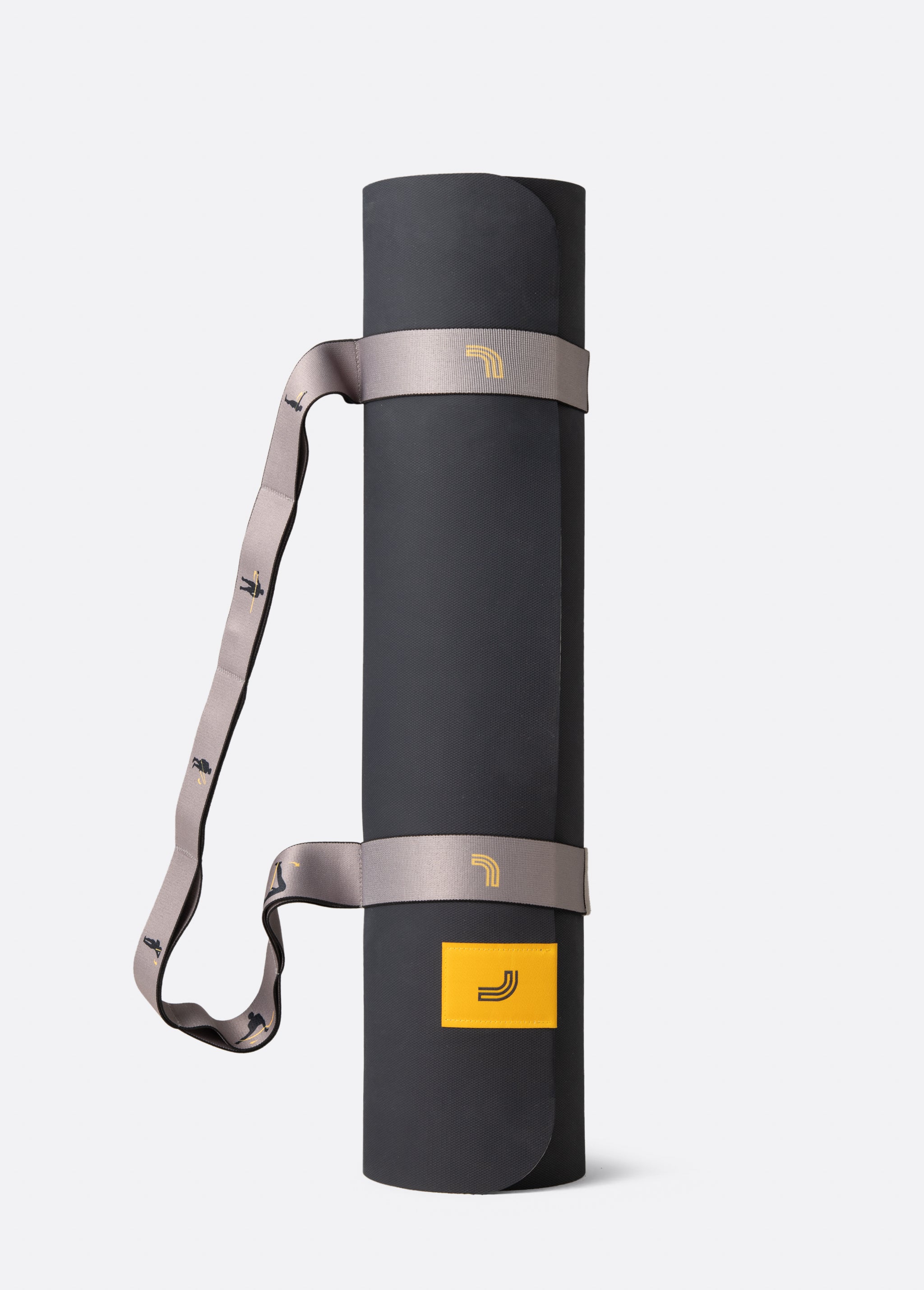 Lolë Pose yoga mat in taupe, rolled upright and secured with the matching taupe carry strap