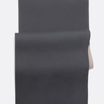 Lolë Pose yoga mat in taupe, laid flat and folded back to reveal the charcoal underside beneath the taupe top