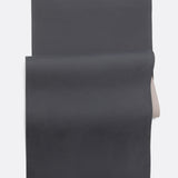 Lolë Pose yoga mat in taupe, laid flat and folded back to reveal the charcoal underside beneath the taupe top