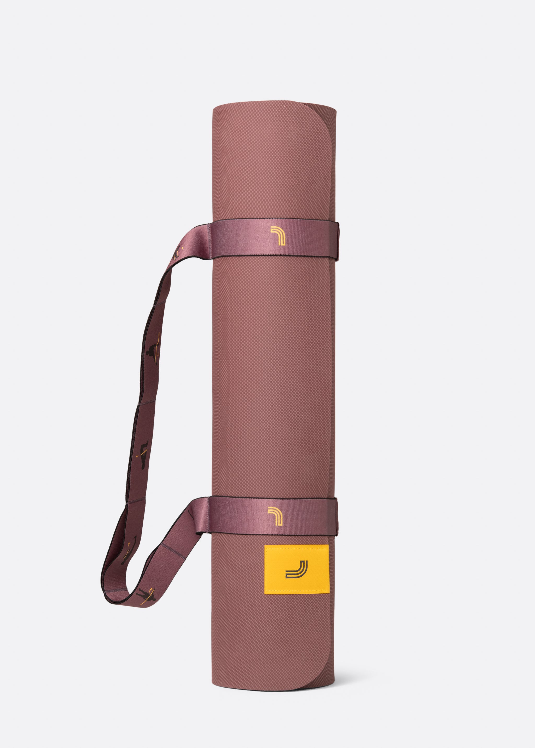 Lolë Pose yoga mat in dusty rose, rolled up with the matching shoulder strap wrapped around it
