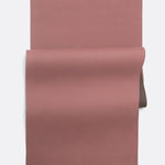 Lolë Pose yoga mat in dusty rose, unrolled flat showing the rose top with a taupe underside at the roll