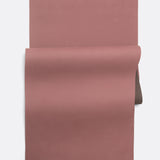 Lolë Pose yoga mat in dusty rose, unrolled flat showing the rose top with a taupe underside at the roll