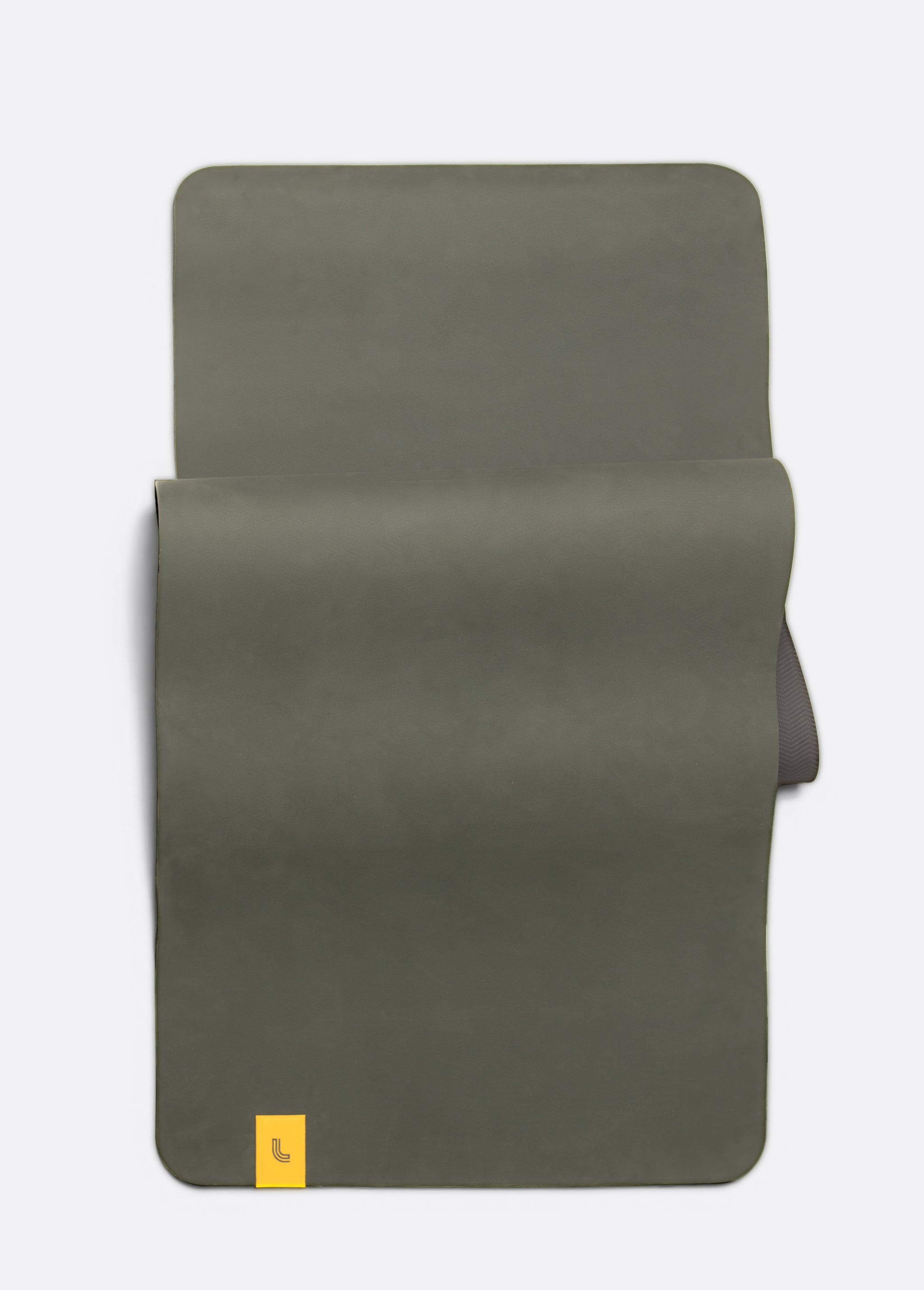 Lolë Pose yoga mat in olive green, unrolled flat showing the olive top and charcoal underside at the roll edge