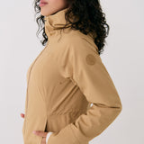 Lolë Element Long Rain Jacket in Carmel tan — shake off wet weather with this longline rain jacket