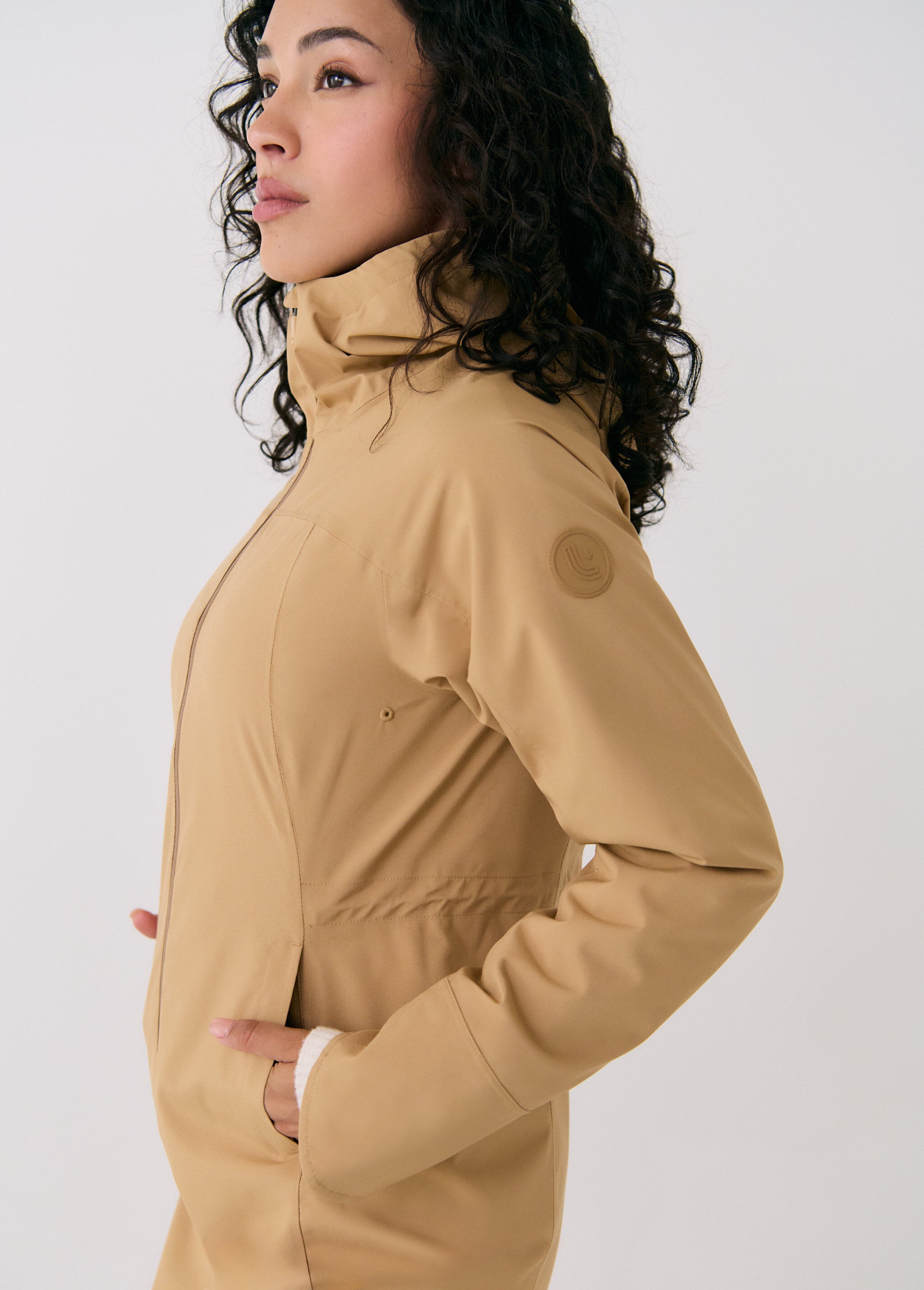 Lolë Element Long Rain Jacket in Carmel tan — shake off wet weather with this longline rain jacket