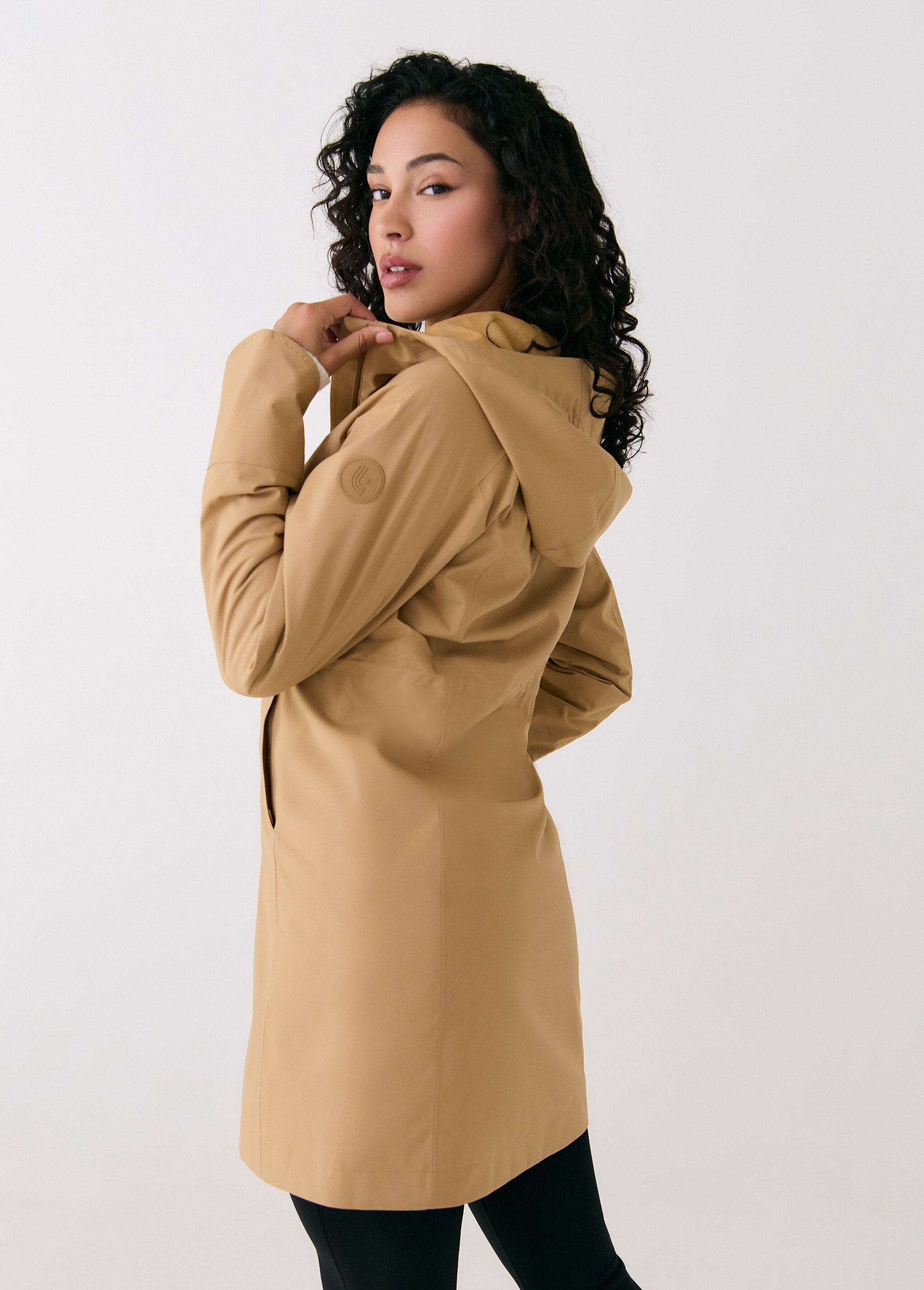 Lolë Element Long Rain Jacket in Carmel tan — shake off wet weather with this longline rain jacket