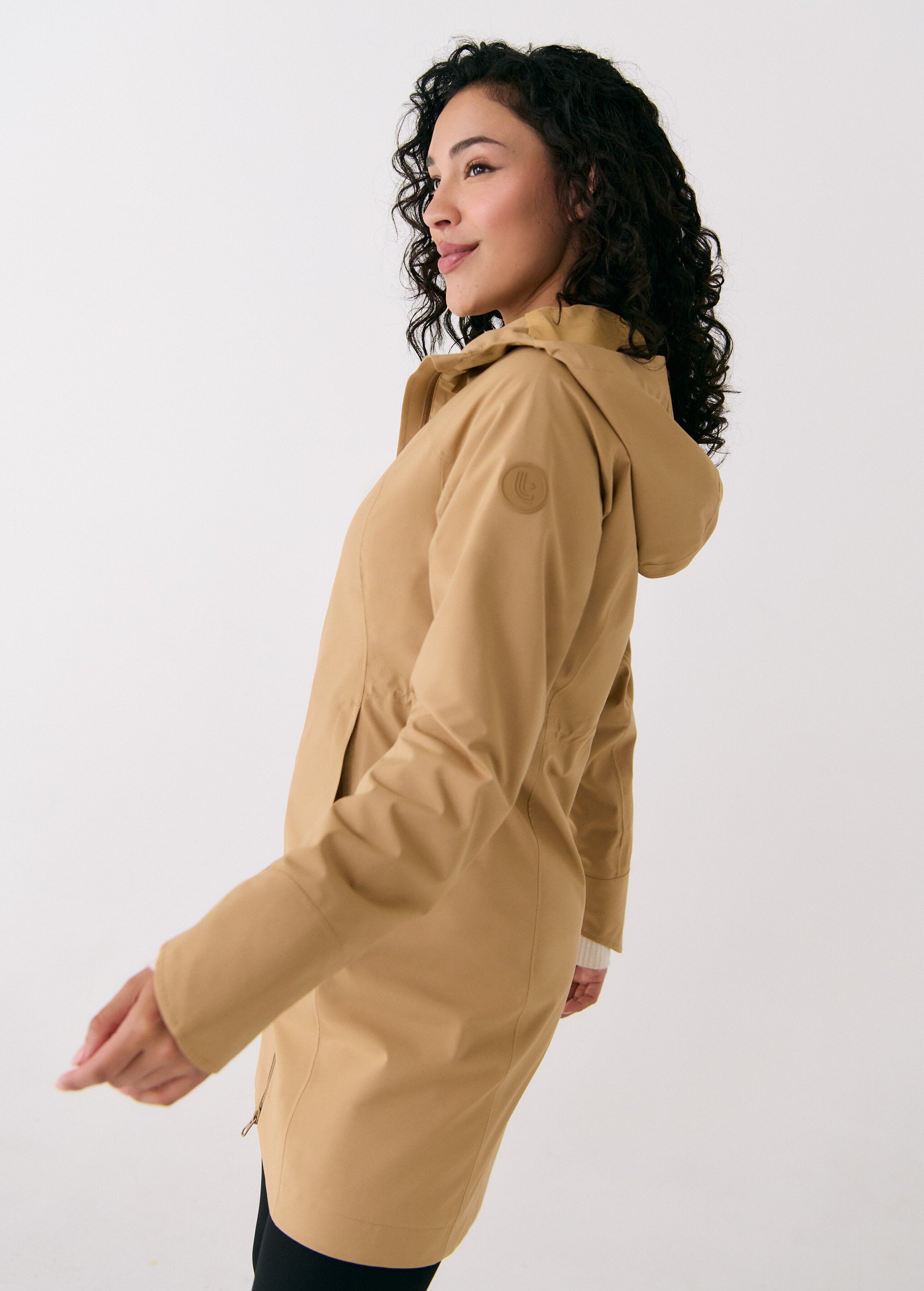 Lolë Element Long Rain Jacket in Carmel tan — shake off wet weather with this longline rain jacket